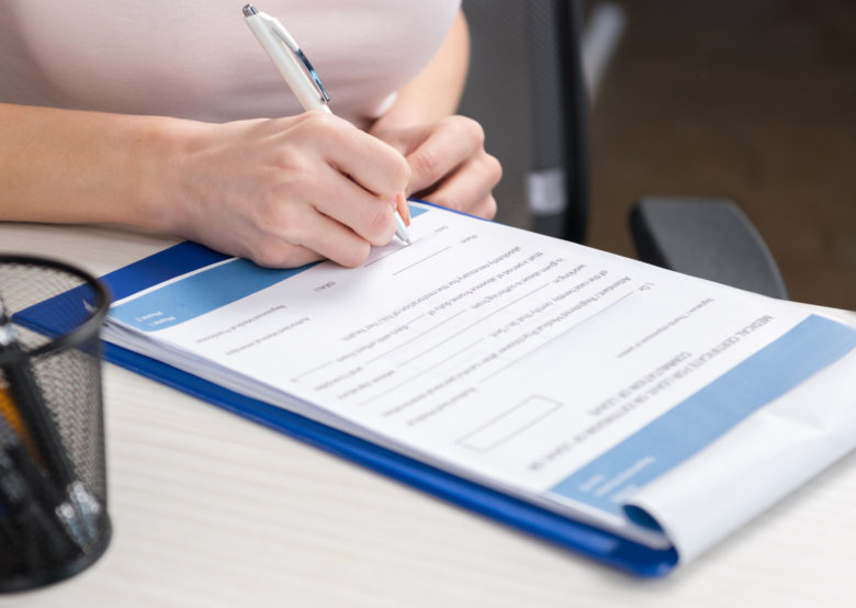 person filling out patient registration forms