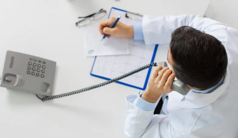 Doctor on the phone making a referral